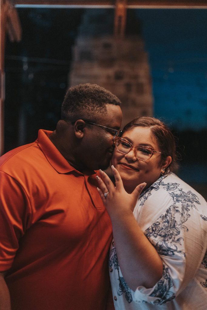 Elegant engaged couple posing during golden hour, captured in a romantic editorial-style photoshoot.